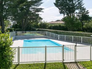 a swimming pool with a white fence around it at Appartement Cosy 3* avec Terrasse, Piscine et Parking Privé à 10 min de la Plage d’Erromardie - FR-1-4-524 in Saint-Jean-de-Luz