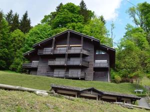 a building with balconies on the side of a hill at Appartement Le Grand-Bornand, 2 pièces, 5 personnes - FR-1-241-198 in Le Grand-Bornand