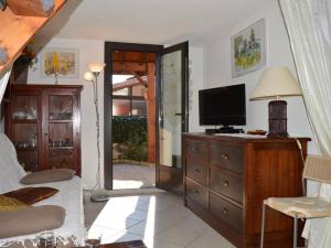 a bedroom with a bed and a television on a dresser at Maison Saint-Cyprien, 3 pièces, 6 personnes - FR-1-225D-532 in Saint Cyprien Plage