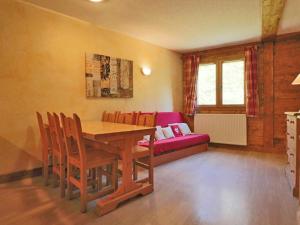 a dining room with a table and chairs and a couch at Appartement Montvalezan-La Rosière, 2 pièces, 6 personnes - FR-1-398-507 in La Rosière