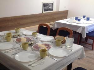 a table with plates of food on it at Guesthouse Family Bosnic in Plitvička Jezera +15 photos