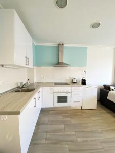 卡拉德米哈斯的住宿－Beach apartment LA CALA DE MIJAS，厨房配有白色橱柜和炉灶烤箱。