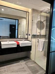 łazienka z 2 umywalkami i dużym lustrem w obiekcie The RED w Kuala Lumpur
