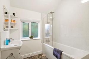 a white bathroom with a sink and a shower at Stylish 4 Bed House in Yorkshire - Football Table in Pontefract