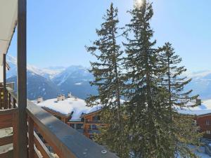 two pine trees on a balcony with snow covered mountains at Appartement Montvalezan-La Rosière, 2 pièces, 5 personnes - FR-1-398-547 in La Rosière