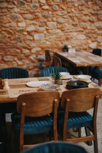 a wooden table with chairs and plates on it at Fibar Hotel Zincirlihan in Aydın