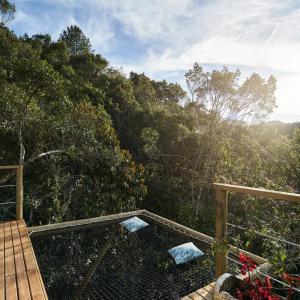 a wooden deck with a view of a forest at BubbleSky Glamping 40 min from Medellin in El Retiro