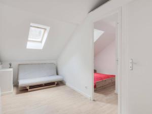 a white room with a bed and a mirror at Appartement Cauterets, 2 pièces, 6 personnes - FR-1-401-145 in Cauterets