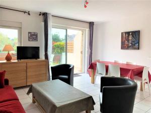 a living room with a red table and chairs at Villa Quiberon, 3 pièces, 6 personnes - FR-1-478-30 in Quiberon