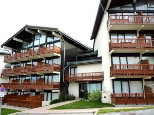 an apartment building with balconies and a street at Studio Montvalezan-La Rosière, 1 pièce, 4 personnes - FR-1-398-575 in La Rosière