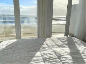 Bett in einem Schlafzimmer mit Meerblick in der Unterkunft Appartement Quiberon, 2 pièces, 3 personnes - FR-1-478-81 in Quiberon