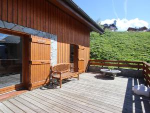 a wooden deck with a bench and a table at Chalet Landry, 5 pièces, 12 personnes - FR-1-411-545 in Landry