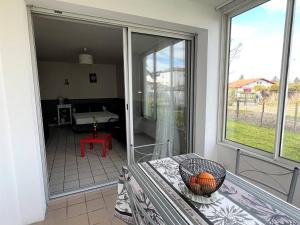 a room with a sliding glass door with a table at Studio Cambo-les-Bains, 1 pièce, 2 personnes - FR-1-495-63 in Cambo-les-Bains