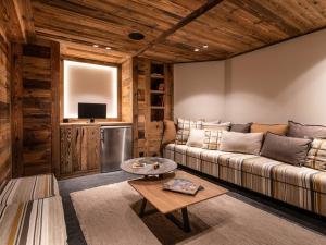 a living room with a couch and a table at Chalet Montvalezan-La Rosière, 8 pièces, 12 personnes - FR-1-398-622 in Montvalezan