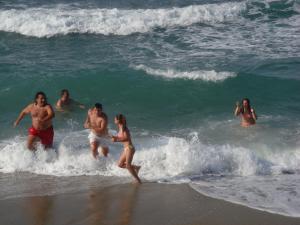 ネア・メサカラにあるVilla Yiannaの海水浴場で遊ぶ人々