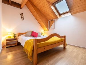 a bedroom with a bed with a yellow blanket and a window at Appartement duplex Saint-Lary 6 pers, 2 ch, mezzanine, balcon - FR-1-296-302 in Saint-Lary-Soulan