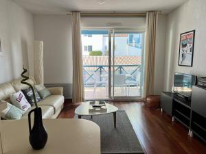 a living room with a couch and a table at Appartement T2 à Cambo-les-Bains avec piscine, terrasse et parking privé, proche des thermes - FR-1-495-82 in Cambo-les-Bains