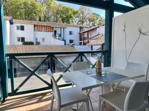 a table and chairs on a balcony with a view at Appartement T2 à Cambo-les-Bains avec piscine, terrasse et parking privé, proche des thermes - FR-1-495-82 in Cambo-les-Bains