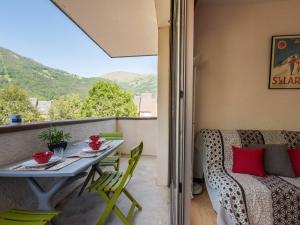 a balcony with a table and chairs and a couch at Appartement confortable 4 pers, 2 chambres, parking, proche centre Saint Lary - FR-1-296-278 in Saint-Lary-Soulan +12 photos