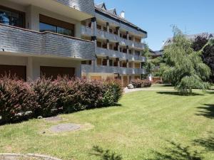 an apartment building with a lawn in front of it at Appartement Saint-Lary-Soulan, 3 pièces, 4 personnes - FR-1-296-278 in Saint-Lary-Soulan