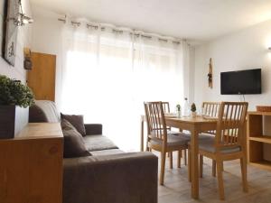 a living room with a couch and a table at Appartement Saint-Lary-Soulan, 2 pièces, 4 personnes - FR-1-457-244 in Saint-Lary-Soulan
