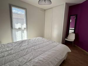 a bedroom with a white bed and a purple wall at Charmant T2, balcon, parking, ascenseur, internet - Itxassou - FR-1-495-47 in Itxassou