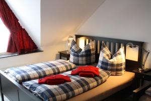 a bedroom with two beds with red shirts on them at Ferienapartments am Brocken in Schierke +37 photos