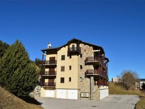 a building with balconies on the side of it at Appartement calme centre station avec parking - FR-1-593-41 in Les Angles
