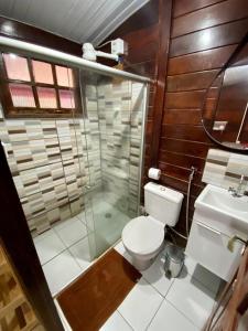 een badkamer met een toilet en een glazen douche bij Pousada do Pescador Eli in Fernando de Noronha