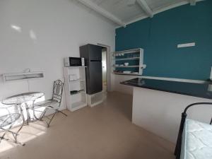 a kitchen with a table and chairs and a refrigerator at Karooland Gastehuis in Middelburg