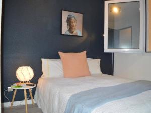 a bedroom with a bed and a table with a lamp at Appart T2 avec terrasse, parking, WIFI, animaux admis - FR-1-225C-31 in Banyuls-sur-Mer