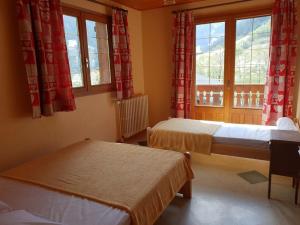 a room with two beds and two windows at Chalet Arêches-Beaufort, 6 pièces, 12 personnes - FR-1-342-198 in Arêches-Beaufort