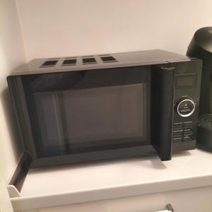a microwave oven sitting on top of a shelf at Stuttgart Holiday 02 in Stuttgart