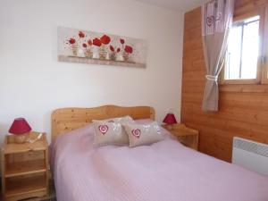 a bedroom with a bed with two pillows and a window at Charmant 3 pièces avec terrasse, stationnement, animaux acceptés à Méribel - FR-1-411-620 in Les Allues
