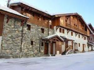 a large stone building with snow on it at Chalet Val Thorens, 6 pièces, 11 personnes - FR-1-545-27 in Val Thorens