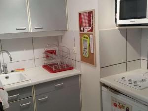 een kleine keuken met een wastafel en een magnetron bij Studio Royan, 1 pièce, 3 personnes - FR-1-494-61 in Royan