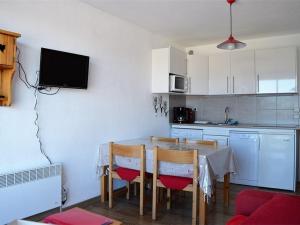 a kitchen with a table and chairs and a kitchen with at Studio Les Angles, 1 pièce, 4 personnes - FR-1-593-8 in Les Angles