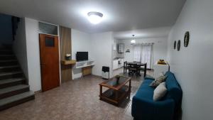 a living room with a blue couch and a table at Nieva 4M in San Salvador de Jujuy