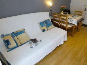 a room with two beds and a table and a dining room at T2 Calme - Balcon - Parking - Animaux admis - FR-1-313-187 in Luchon