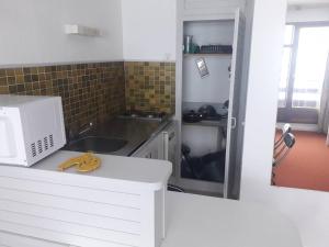 a kitchen with a sink and a microwave on a counter at Studio Arette, 1 pièce, 4 personnes - FR-1-602-12 in Arette