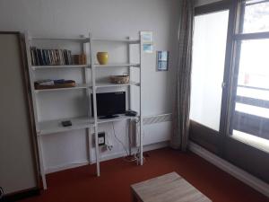 a living room with white shelves and a television at Studio Arette, 1 pièce, 4 personnes - FR-1-602-12 in Arette