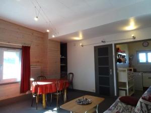 un salon avec une table rouge et une cuisine dans l'établissement Appartement Arette, 3 pièces, 6 personnes - FR-1-602-26, à Arette
