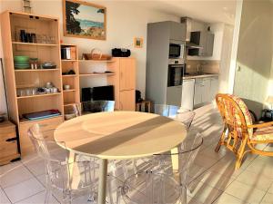 a kitchen with a table and chairs in a room at Studio cabine cosy à Quiberon avec vue mer et garage - FR-1-478-184 in Quiberon +5 photos