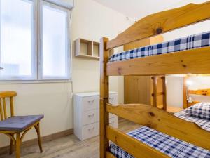 a room with two bunk beds and a chair at Appartement Barèges, 3 pièces, 6 personnes - FR-1-403-96 in Barèges