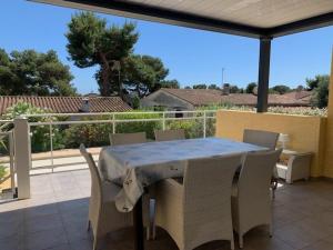 a table and chairs sitting on a patio at Villa climatisée avec piscine privée pour 6 personnes proche plage et port, calme et confortable - FR-1-607-26 in Cap d'Agde