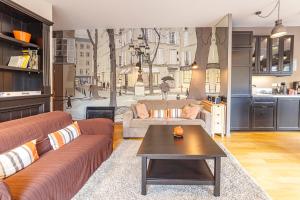 a living room with two couches and a table at L'Atelier de Claire in Le Mont-Dore