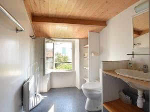 a bathroom with a toilet and a sink and a window at Maison de Charme avec Cour, 2 Chambres, Cuisine Équipée, Proche Village St Clément des Baleines - FR-1-434-74 in Saint-Clément-des-Baleines +15 photos