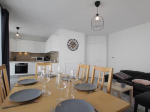 a dining room table with plates and wine glasses at Appartement lumineux 4P/8 pers, 2 terrasses, parking privé, cœur de Briançon - FR-1-330C-119 in Briançon