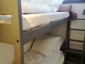 two bunk beds in a room with pillows at Appartement Les Adrets-Prapoutel, 1 pièce, 4 personnes - FR-1-557-75 in Les Adrets