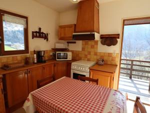 a kitchen with a table and a stove top oven at Chalet Arêches-Beaufort, 4 pièces, 7 personnes - FR-1-342-234 in Beaufort